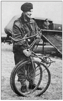 English paratrooper with his folding bike that could be carried on his back during World War II.