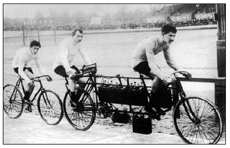 early E-bike in action on a bicycle race track in 1898