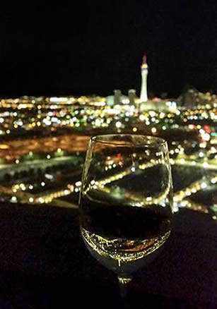 Vegas night skyline through a glass of wine