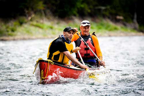 Mark Armstrong and friend canoeing rapids