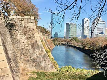 Osaka Castle is protected by high stone walls and a moat.