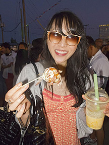 Woman eating a fried fish ball