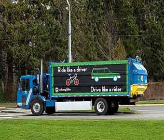Garbage truck with safe cycling message
