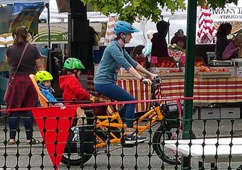 Cargo bike with mom and kids