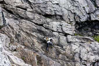 Jason Hardrath climbing rock face