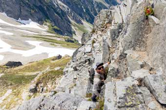 Jason Hardrath climbs to wall ledge