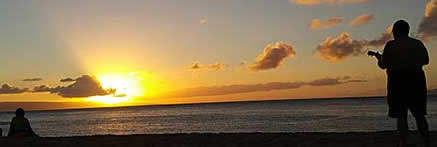 Ukelele playing on beach at sunset