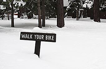 Walk your bike sign in snow