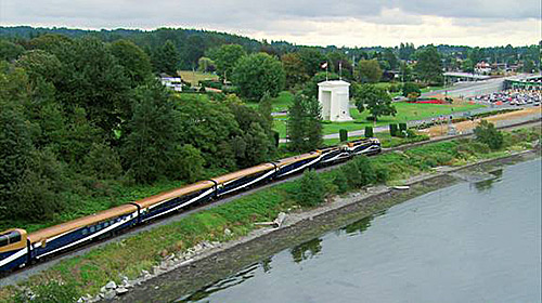 Rocky Mountaineer Train passes the Peace Arch on the way to Seattle 