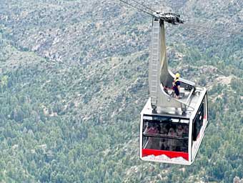 The �cabin attendant� rides the Sandia Peak tram car back down