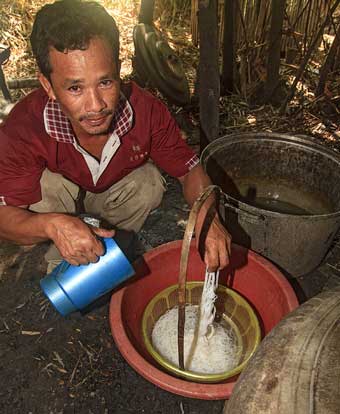 Man making rice noodles on Koh Trong Island across the Mekong River from Kratie, Cambodia.