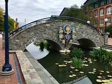 A brick bridge over Carol Creek sports whimsical art.