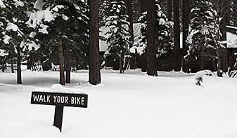 Sign in snow to walk your bike