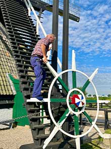 In Kinderdijk a millwright demonstrates the rotation mechanism