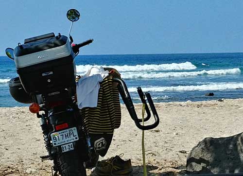 Motorcycle surfboard carrier at Pine Trees Surfing Beach, HI