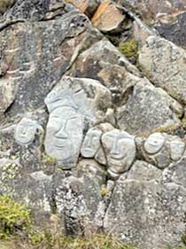 Carved man and fish on stone, Greenland