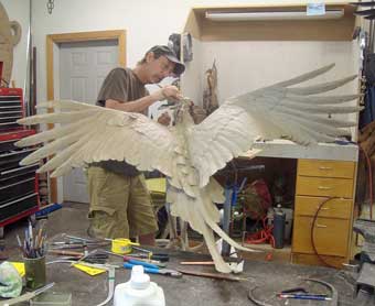 Avian sculptor Stefan Savides putting finishing touches on Mamba Samba