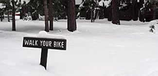 Walk-your-bike sign in snow